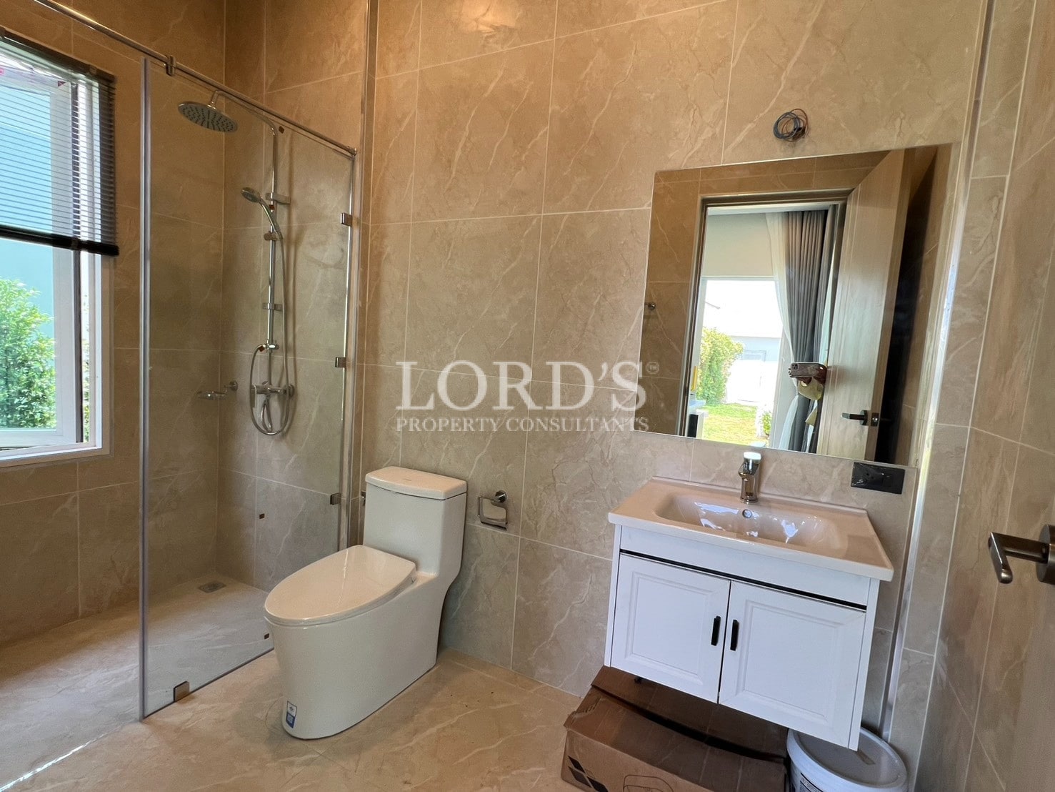 Bathroom with sink, mirror, and warm tiles