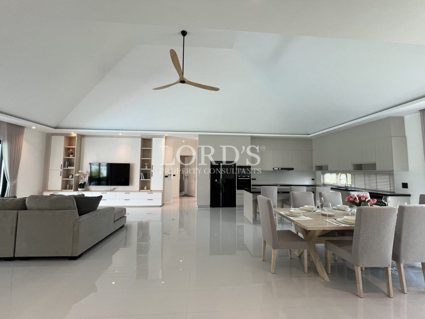 Open living and dining area with ceiling fan