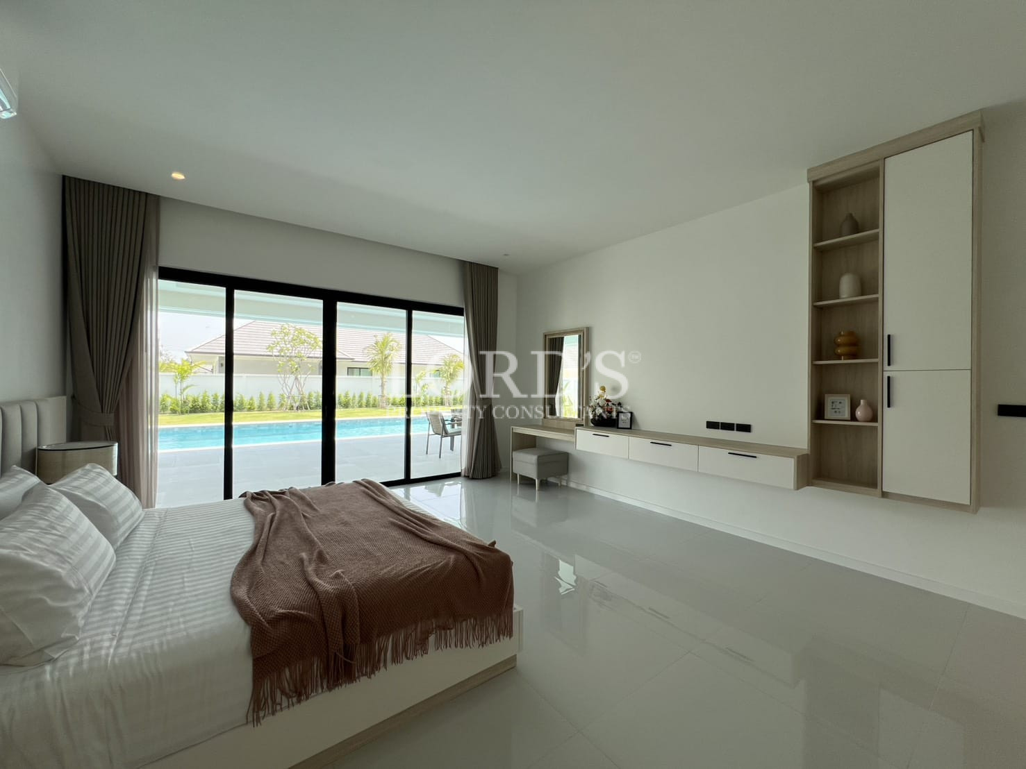 Bedroom with large window overlooking pool
