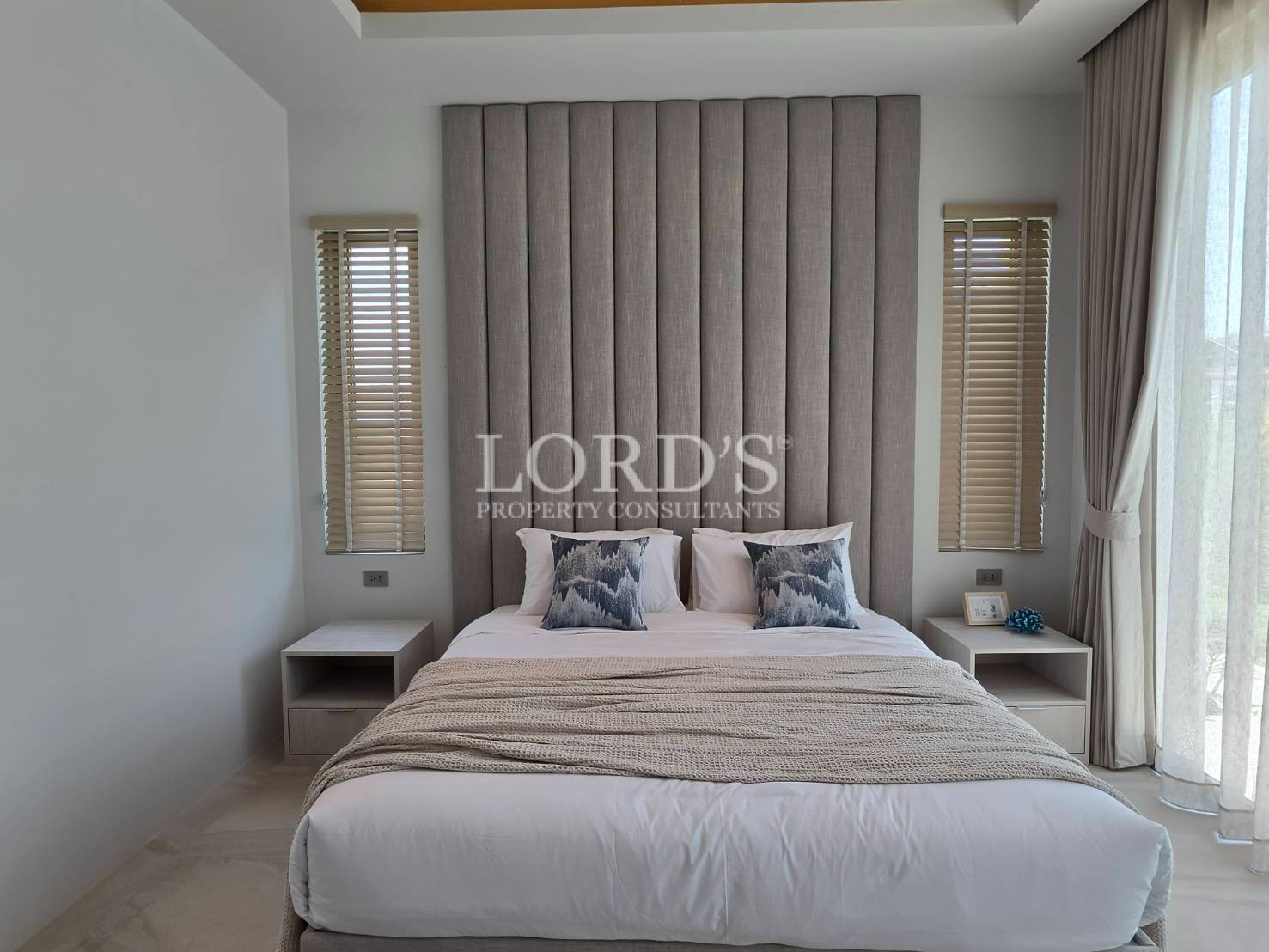 Bedroom with neutral tones and large window