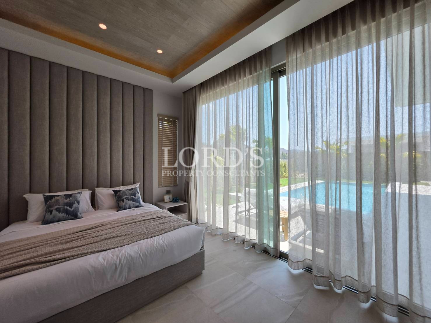 Bedroom with large window and curtains