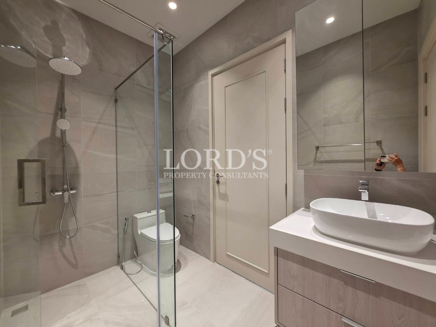 Bathroom with vanity and glass partition shower