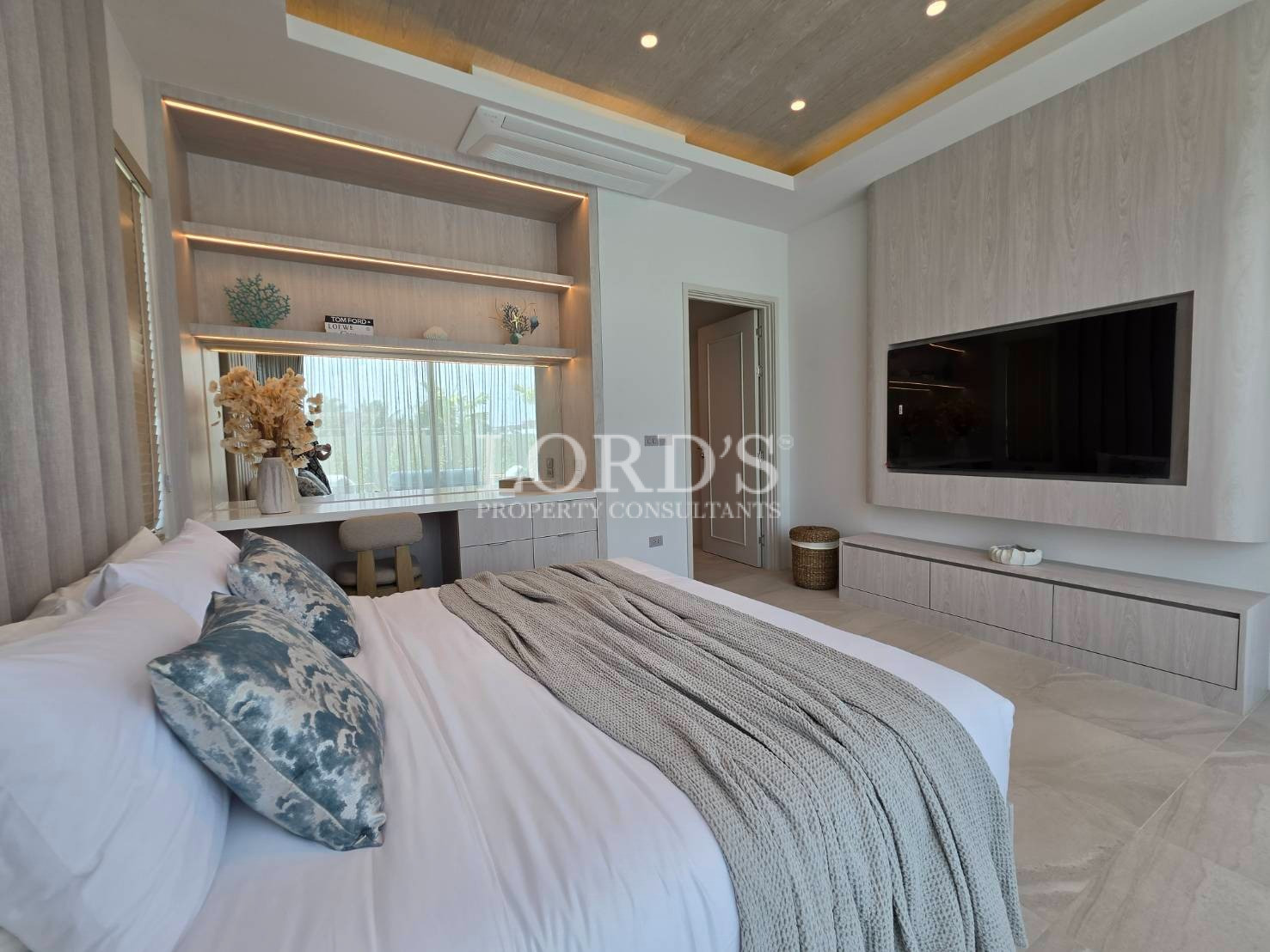 Bedroom with built-in shelves and TV unit