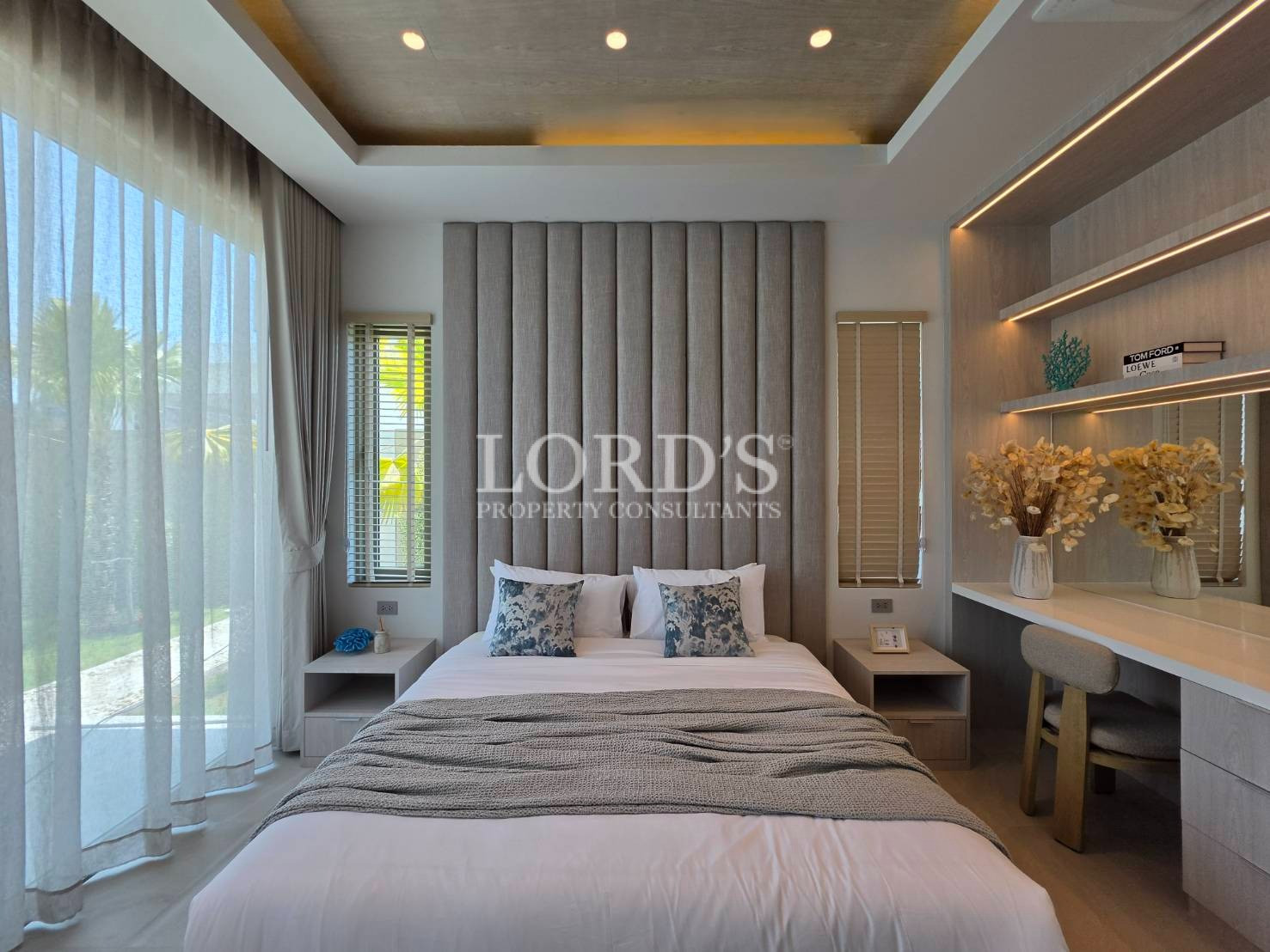 Bedroom with curtains and bedside lighting