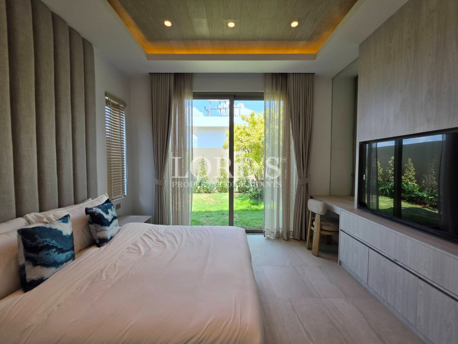Bedroom with large glass doors and garden view
