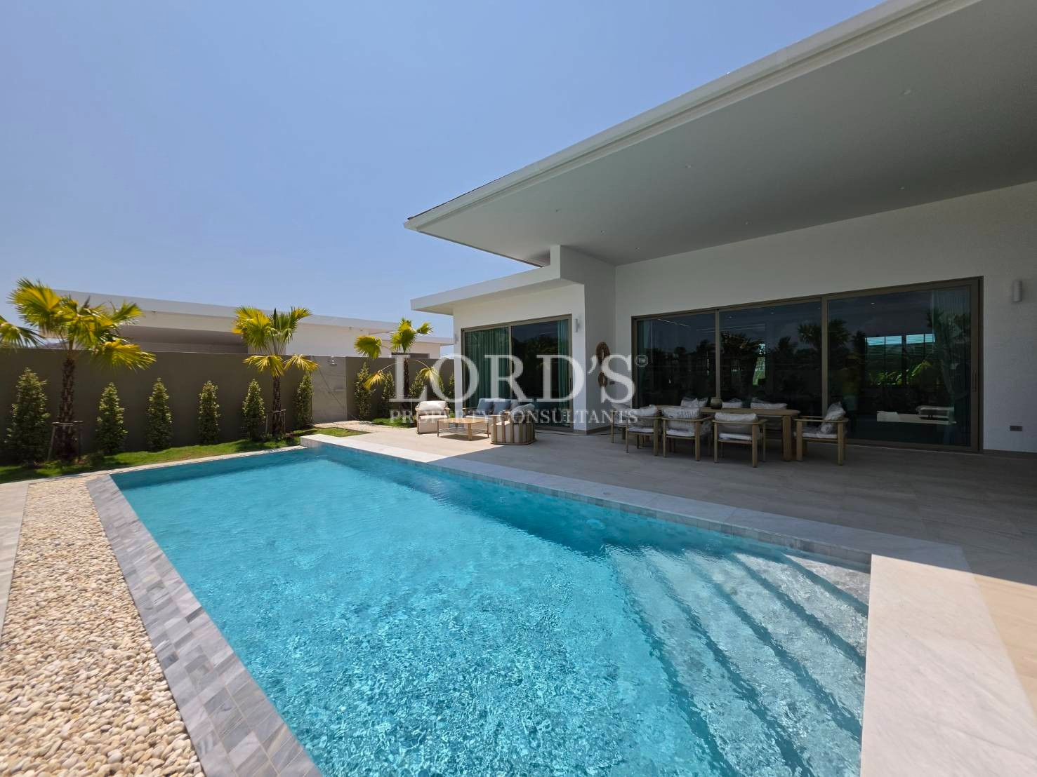 Modern villa exterior with long swimming pool