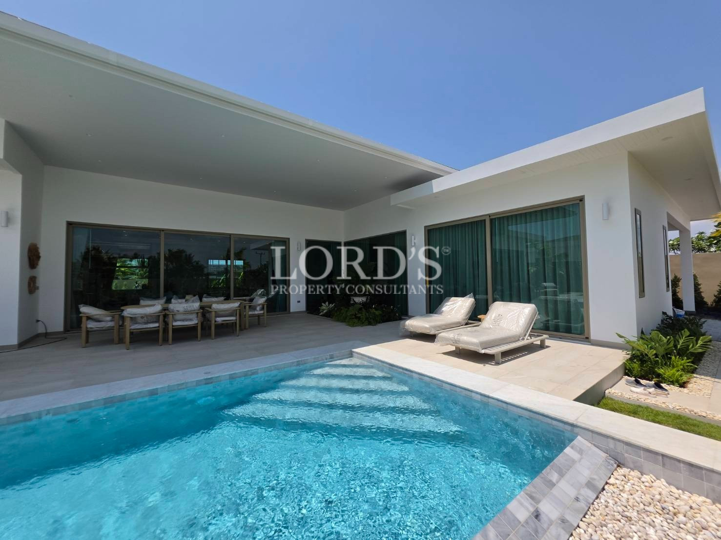 Poolside view with modern villa exterior