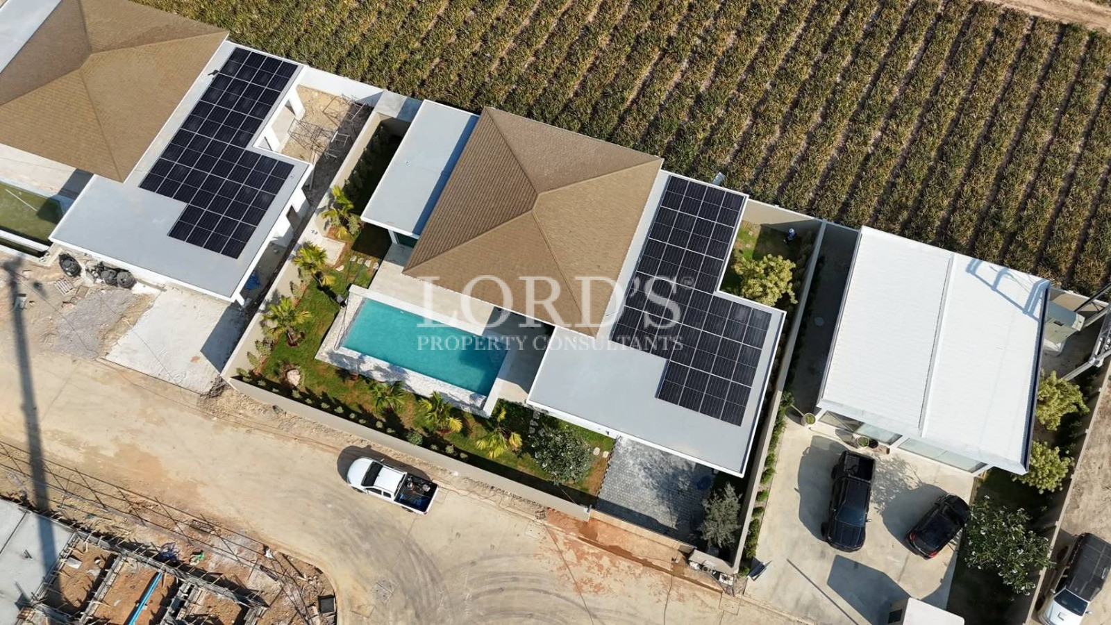 Aerial view of villa with pool and driveway