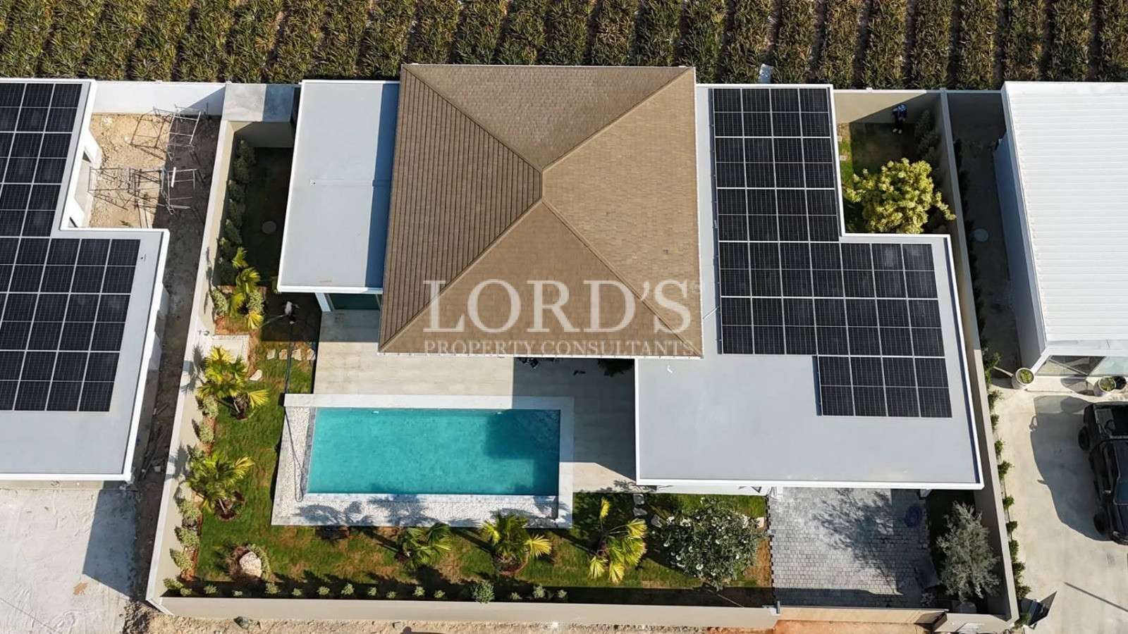 Aerial view of modern house with pool and solar panels