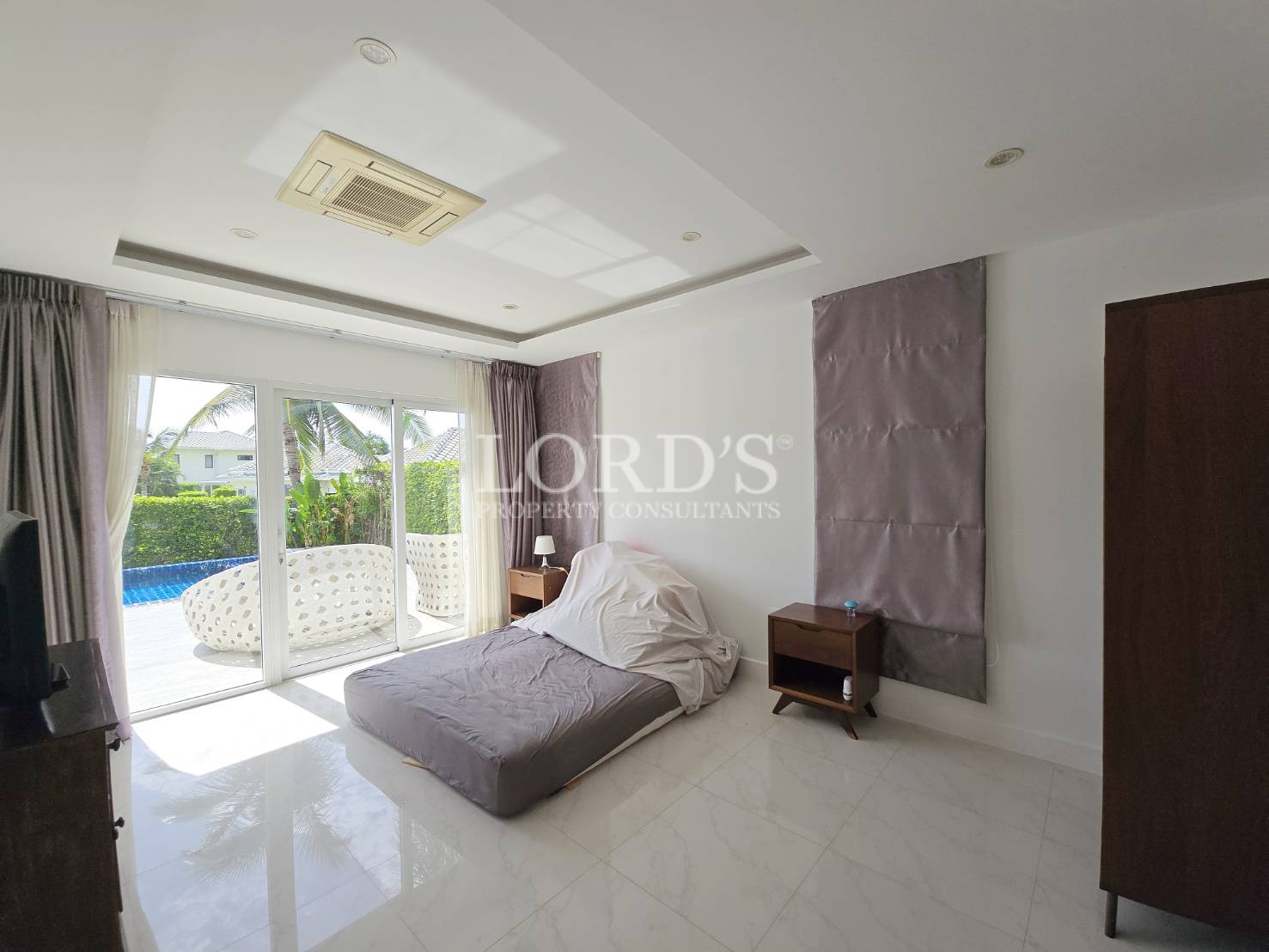 Bedroom with large windows and bed
