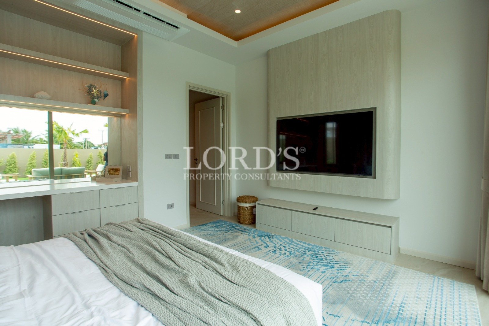 Bedroom with TV wall and wood accents