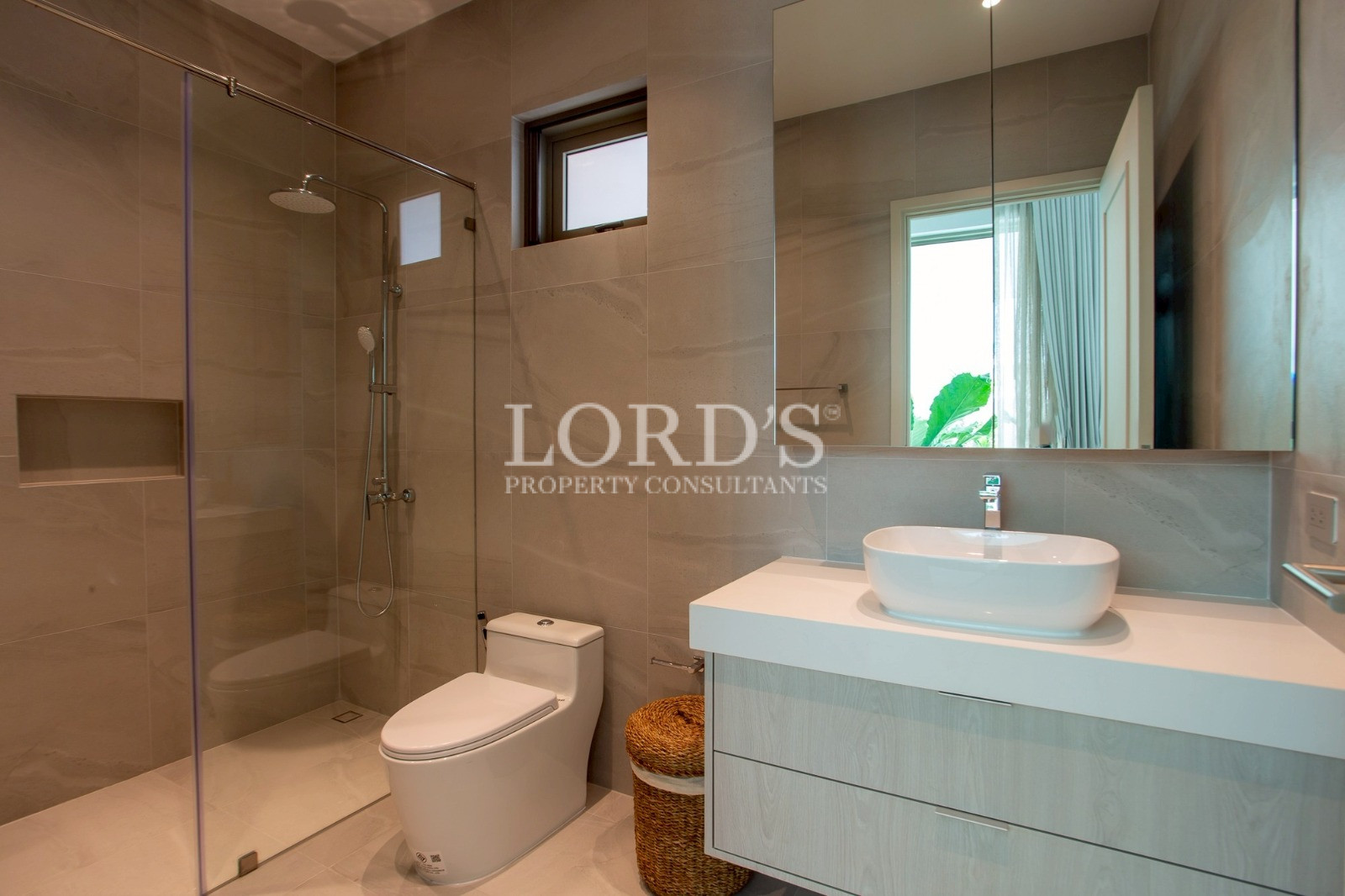 Bathroom with wooden vanity and sink basin