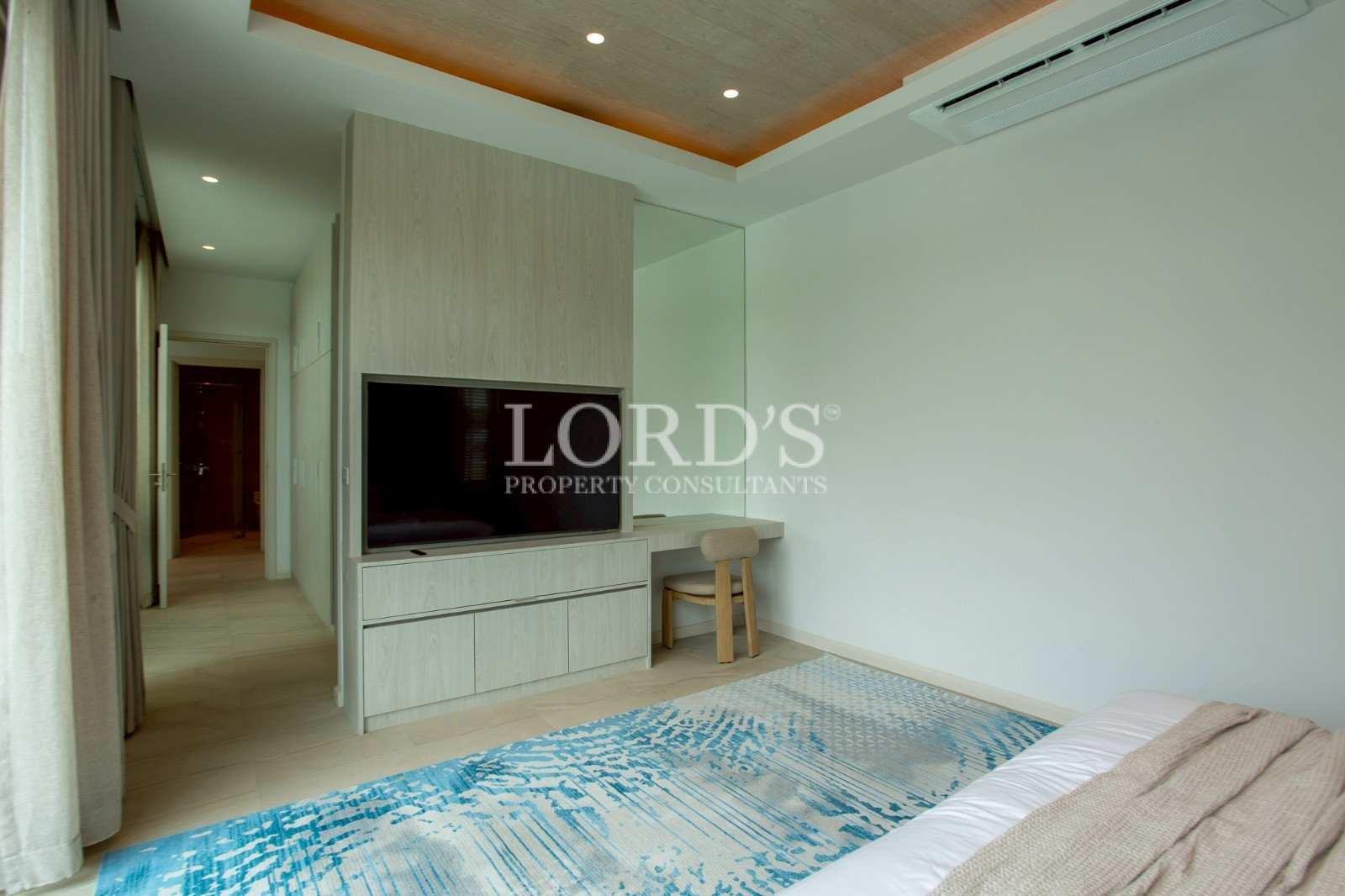 Minimalist bedroom with mounted TV