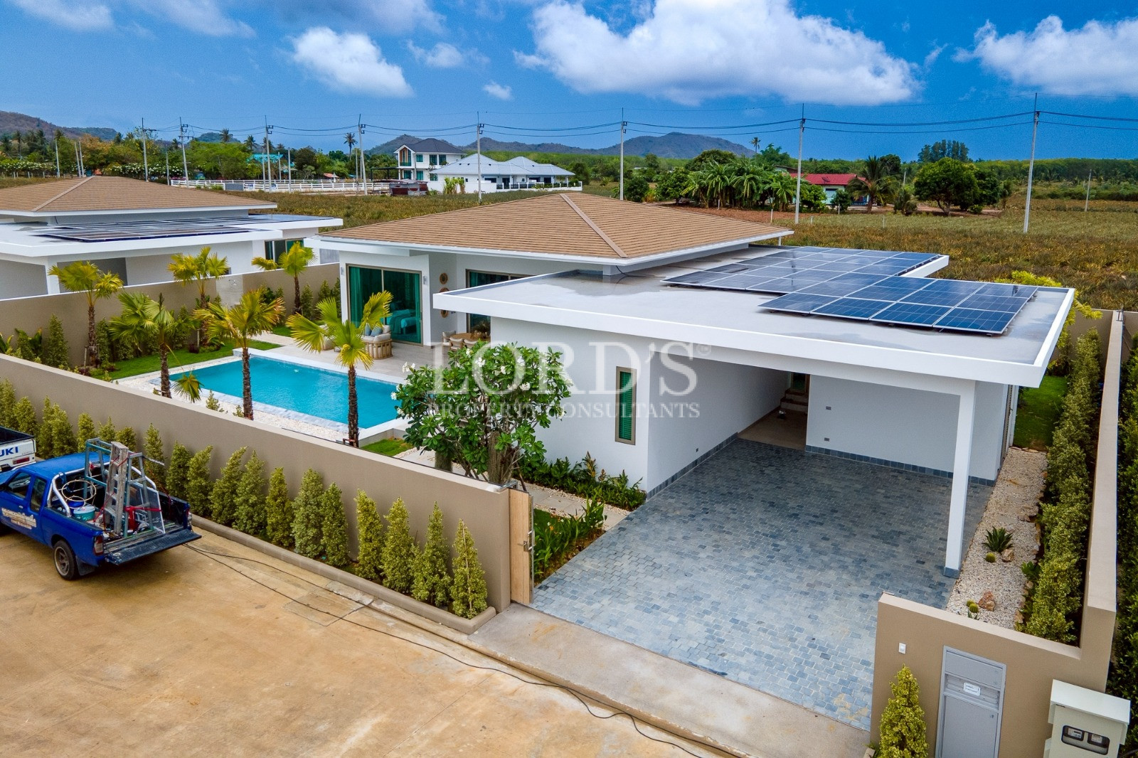 Modern villa exterior with pool and mountains