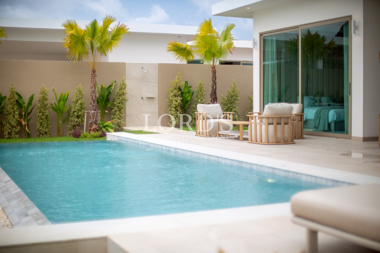 Swimming pool with tropical villa setting