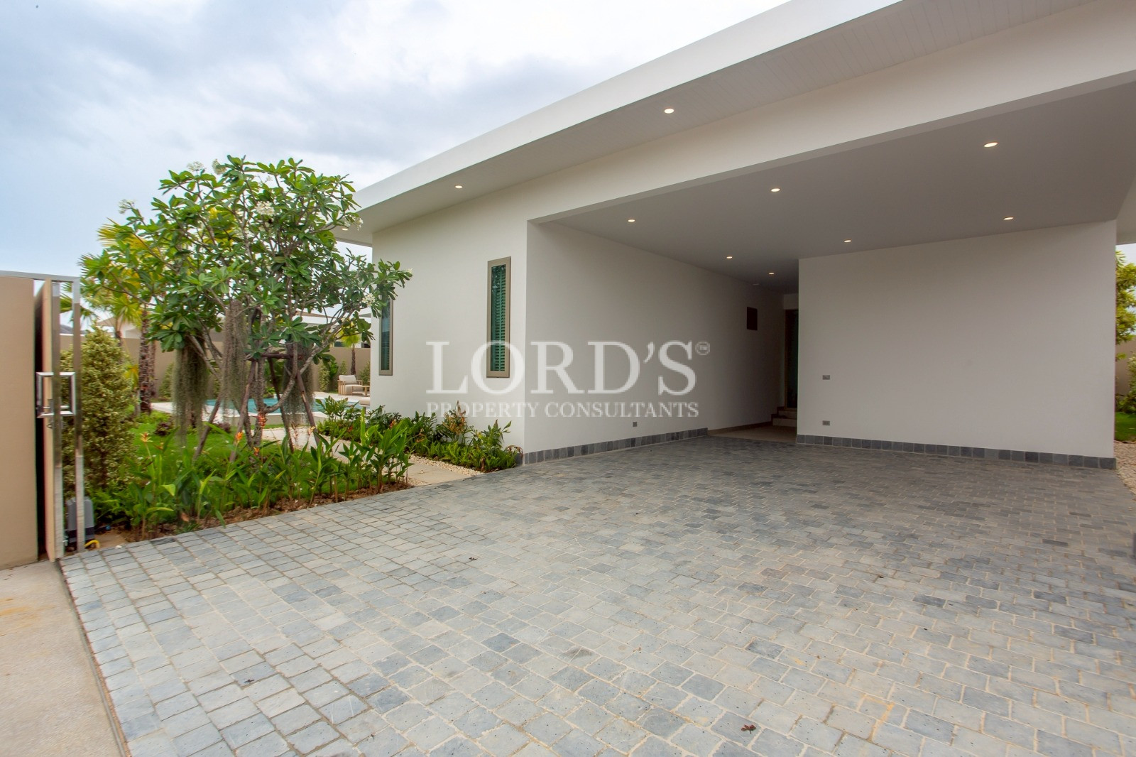 Covered carport with paved driveway