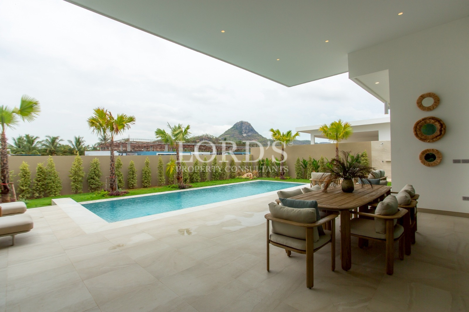Covered poolside terrace with seating