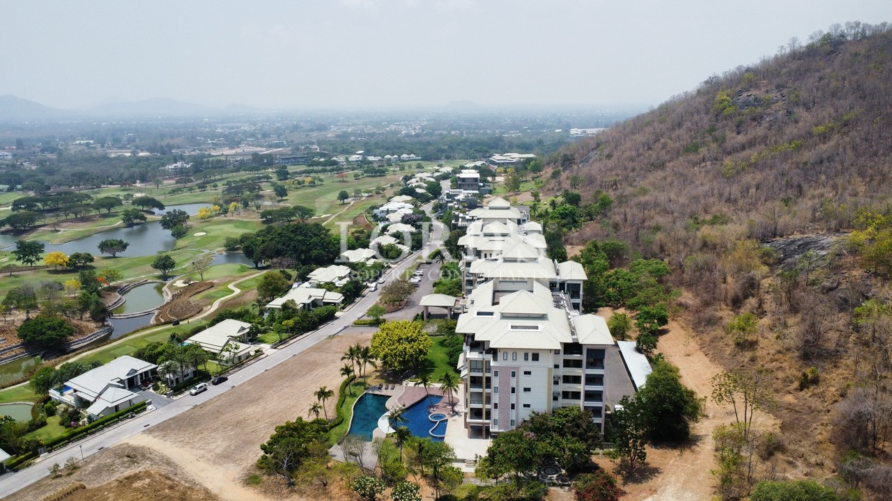Aerial view of buildings near hillside