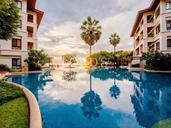 Resort-style swimming pool with palm trees