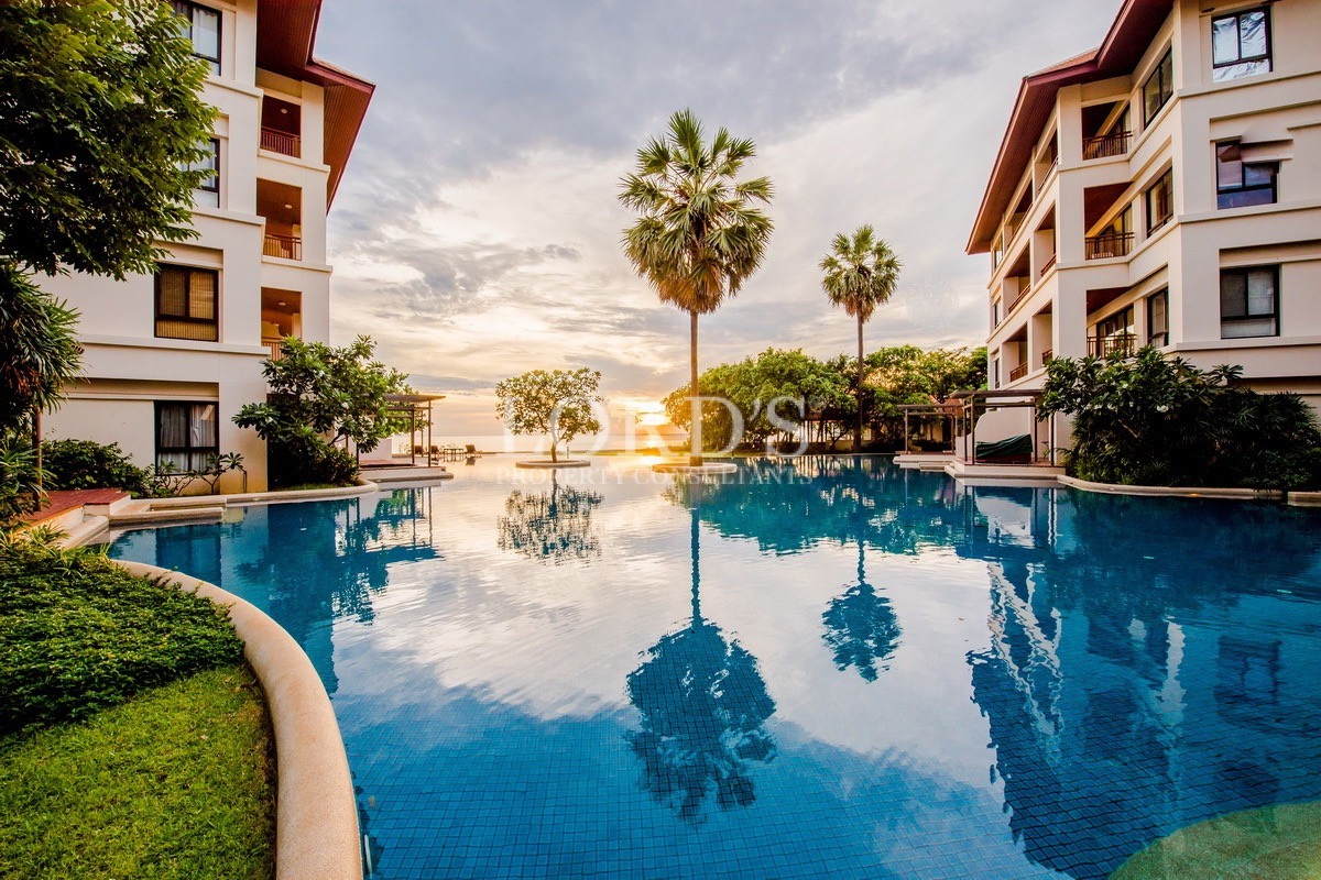 Resort-style swimming pool with palm trees