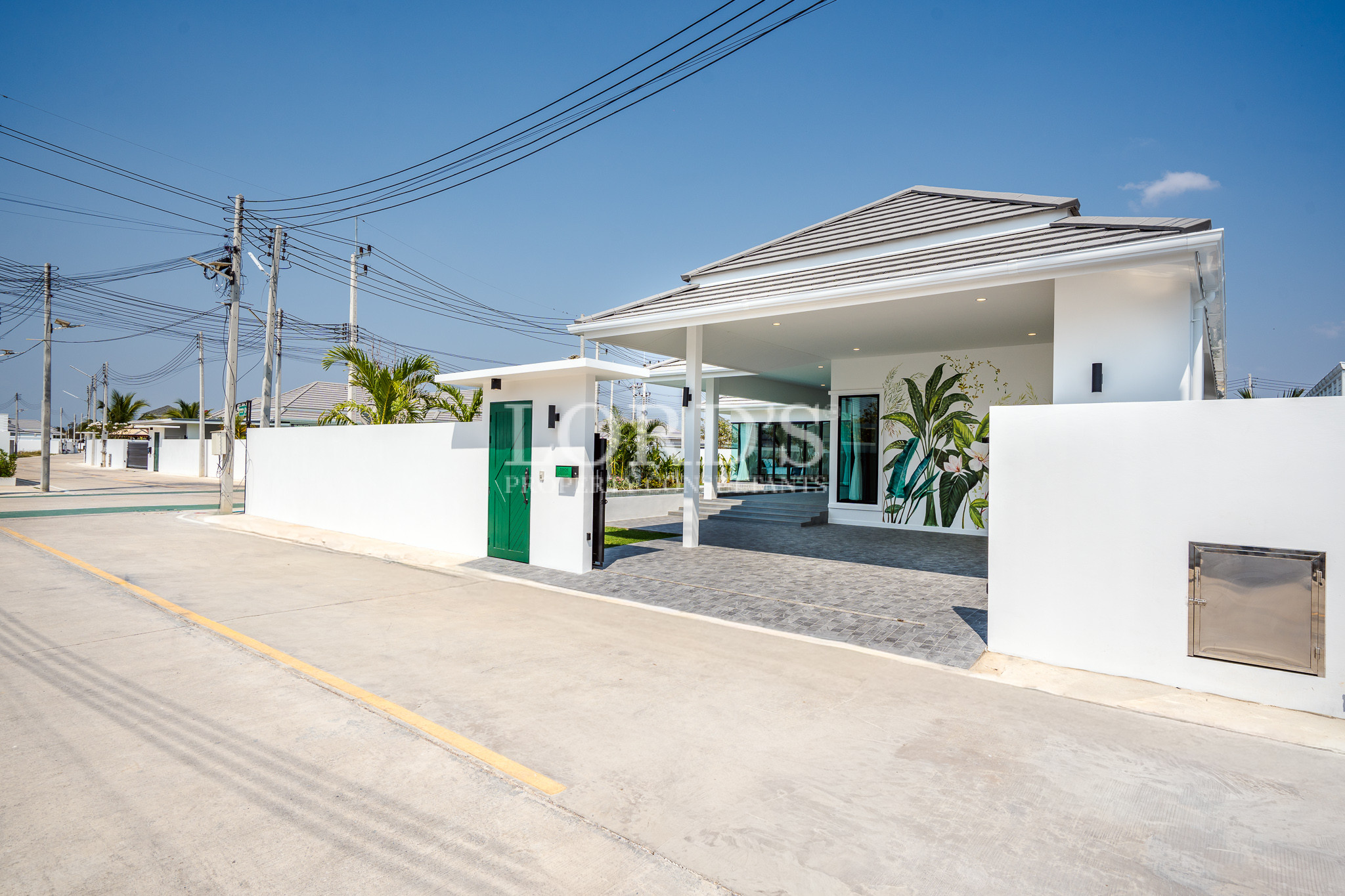 Modern villa entrance with covered driveway
