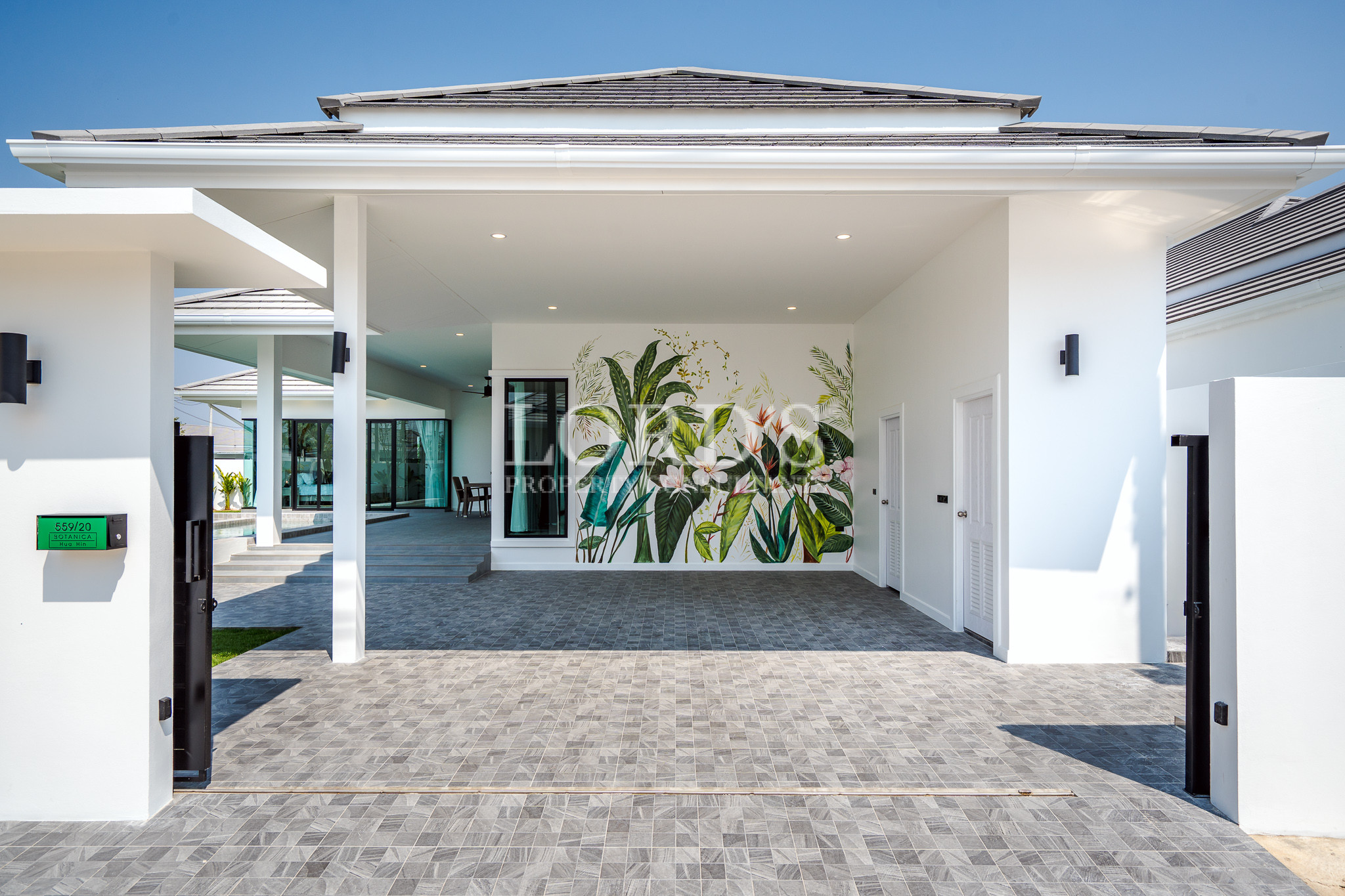 Spacious covered patio with tropical plants