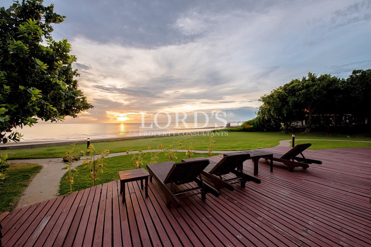 Wooden beachfront deck with lounge chairs