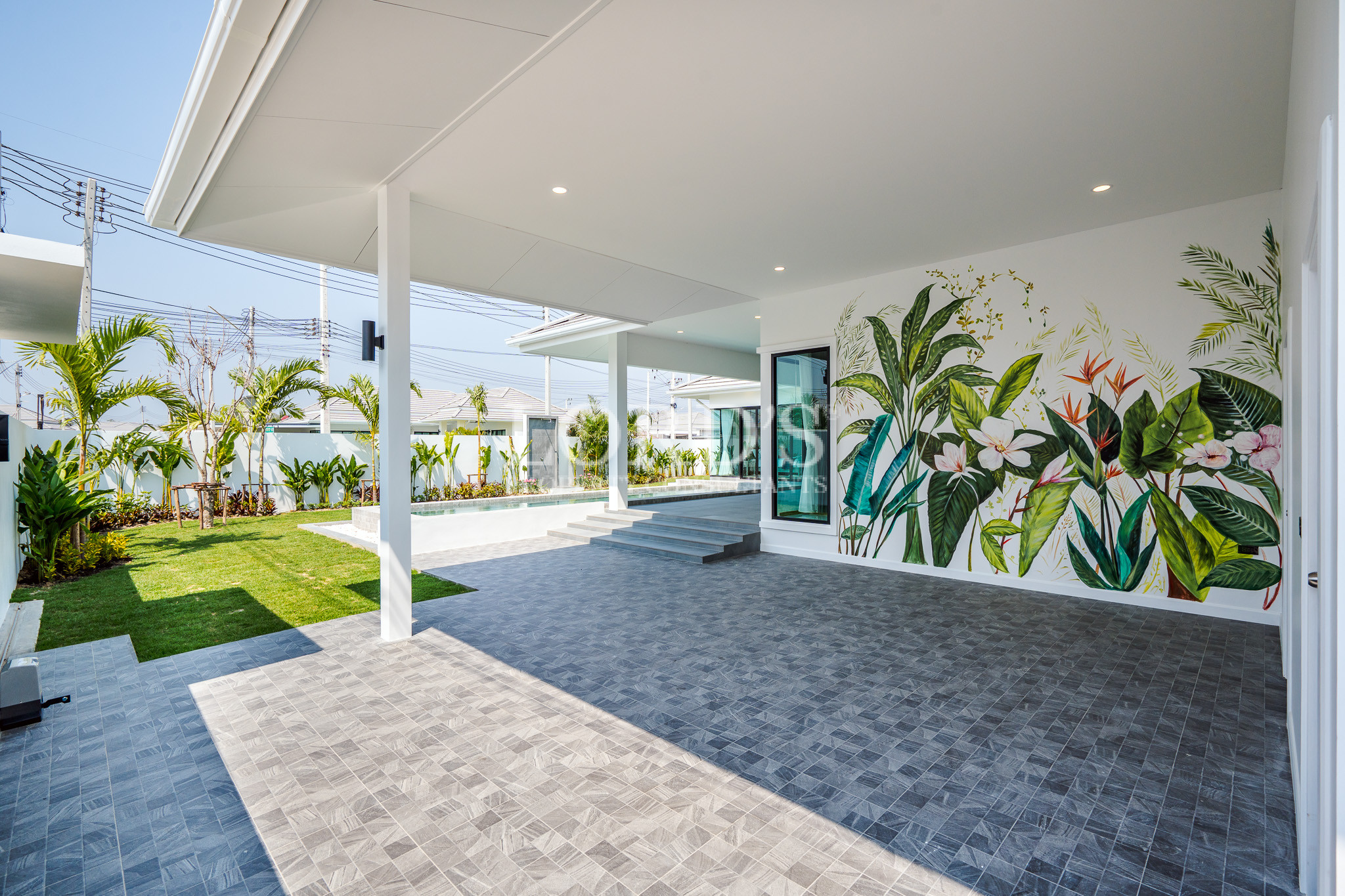 Covered outdoor terrace with landscaped garden