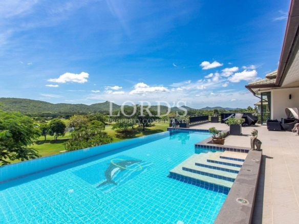 Infinity pool beside luxury villa and mountains