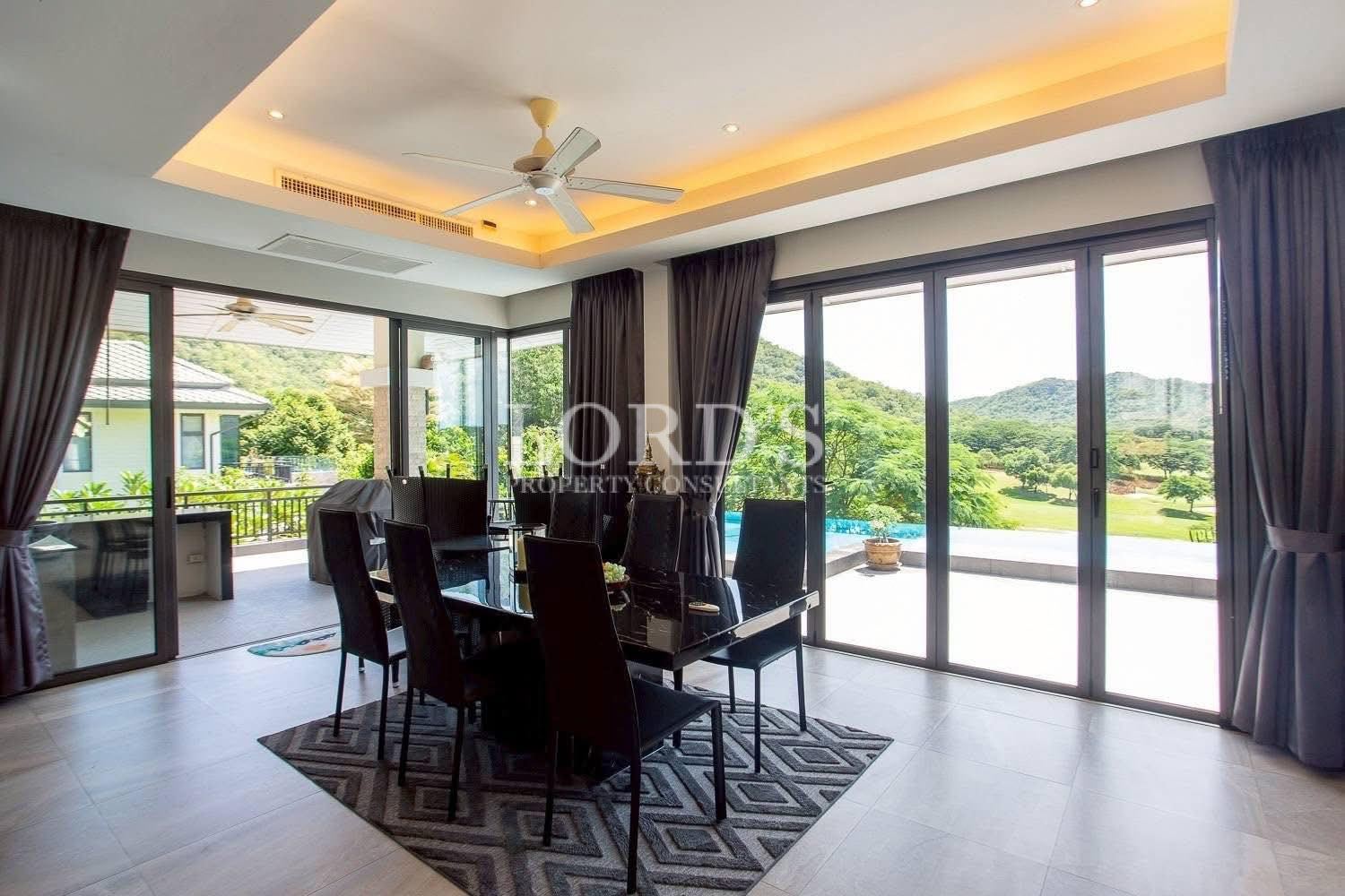 Outdoor dining area with poolside view