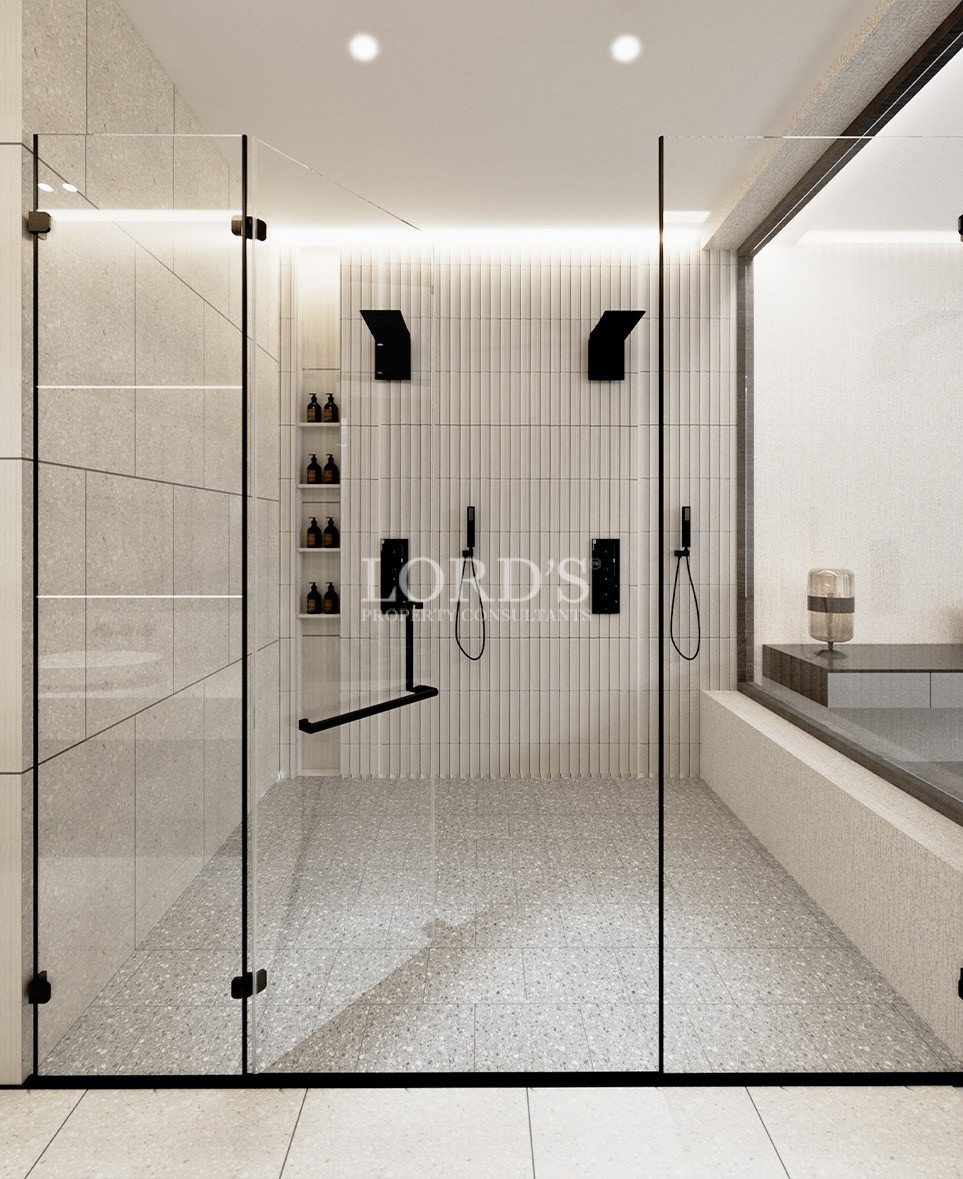 Spacious bathroom with glass shower enclosure