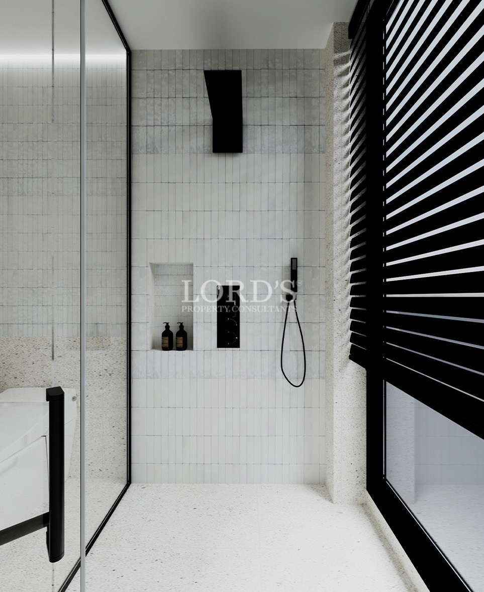 Stylish bathroom with black accent wall and shower