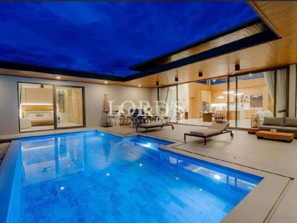 Luxury villa with illuminated pool at night