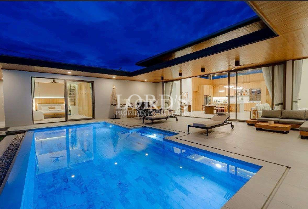 Luxury villa with illuminated pool at night