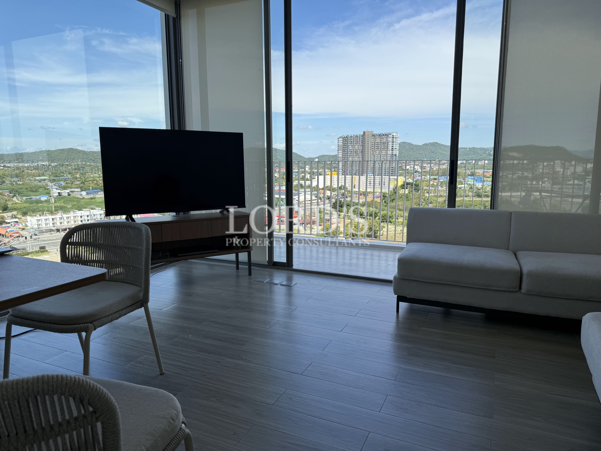 Modern living area with city skyline through windows