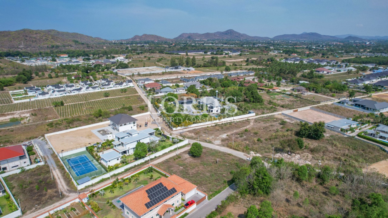 Drone view of residential estate and mountain landscape