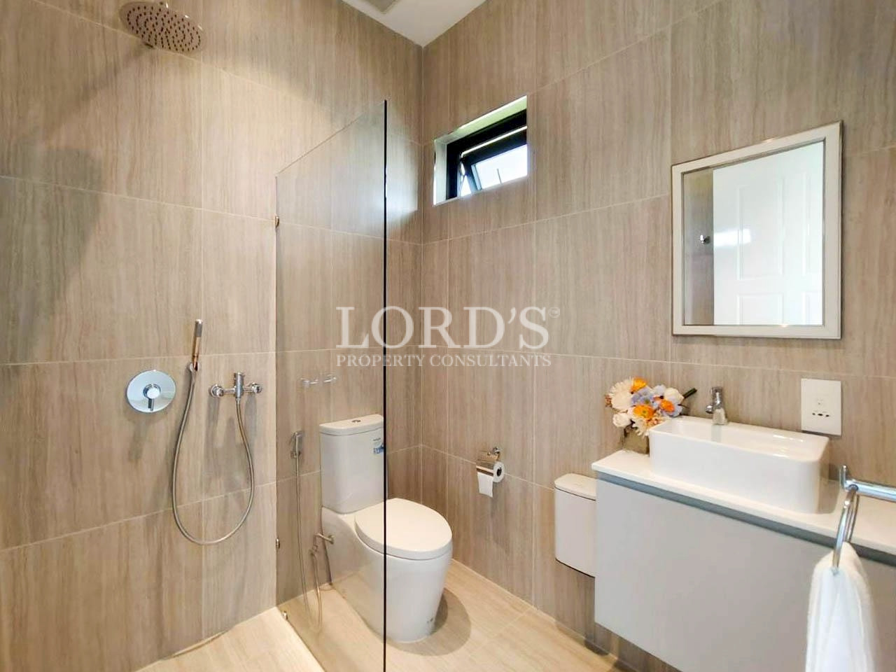 Modern bathroom with glass shower and wooden walls