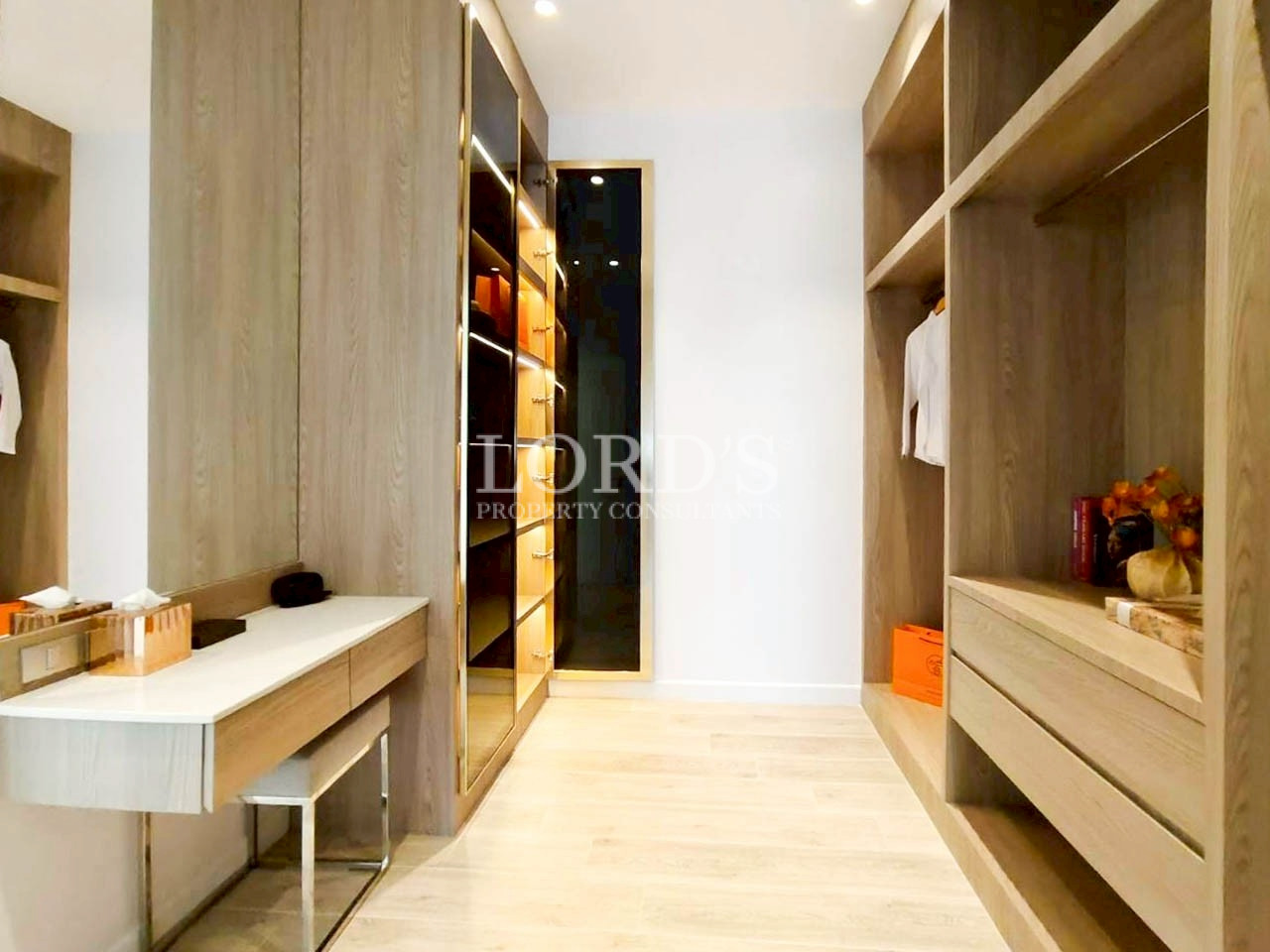 Walk-in closet with built-in shelves and seating