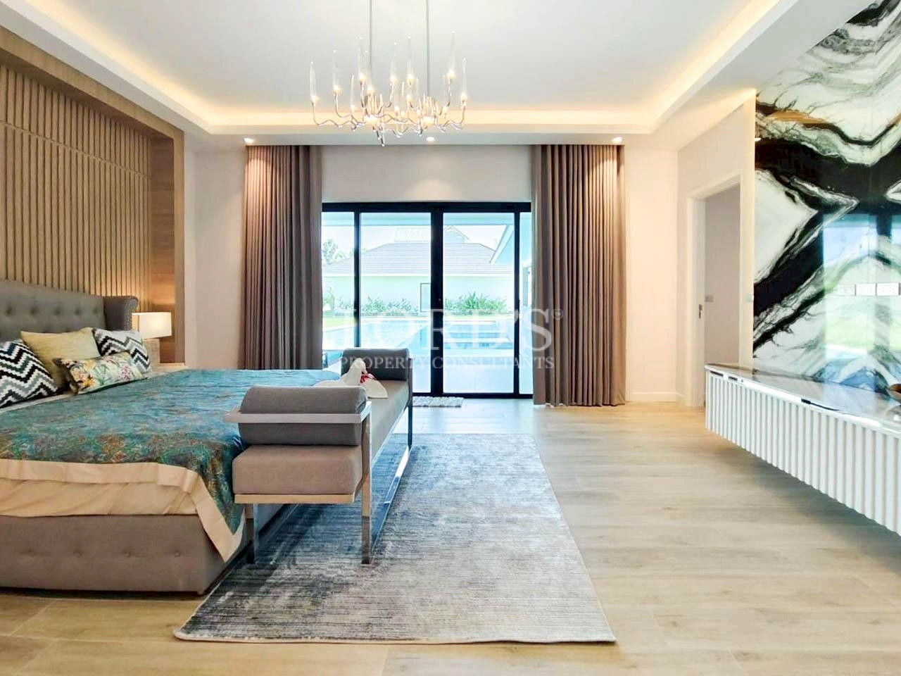 Spacious bedroom with sitting area and chandelier