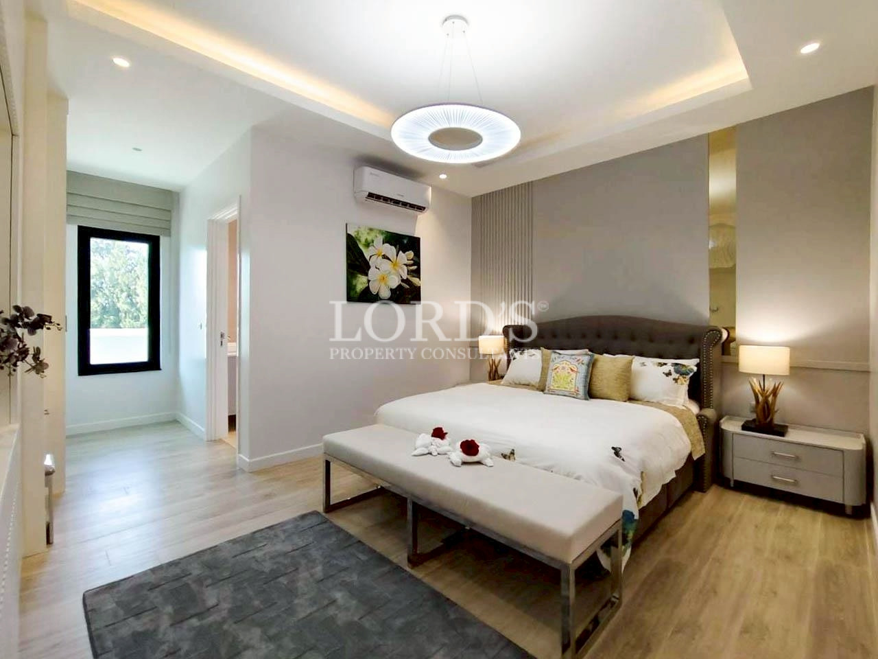 Spacious master bedroom with modern lighting