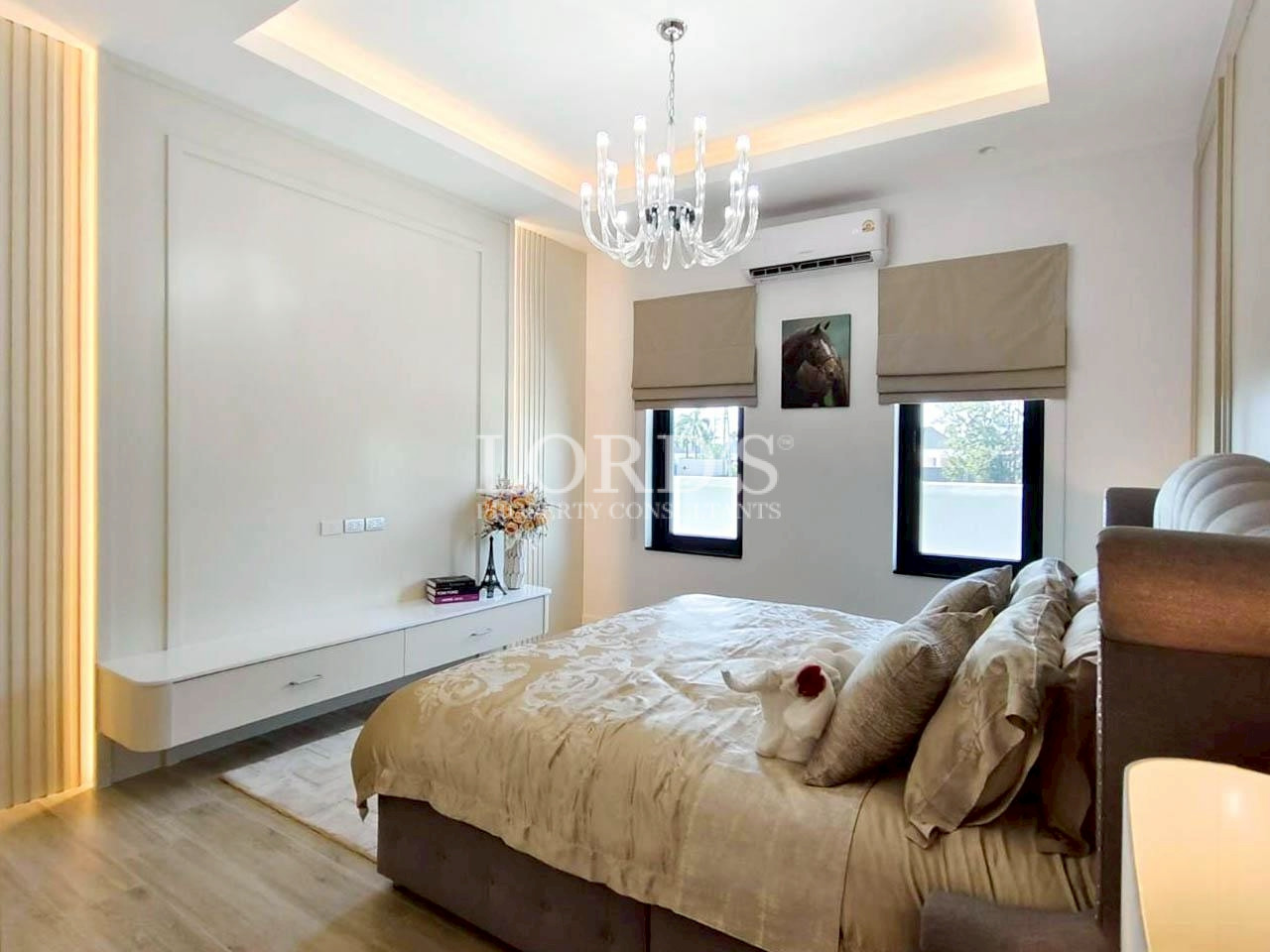 Elegant bedroom with chandelier and soft bedding
