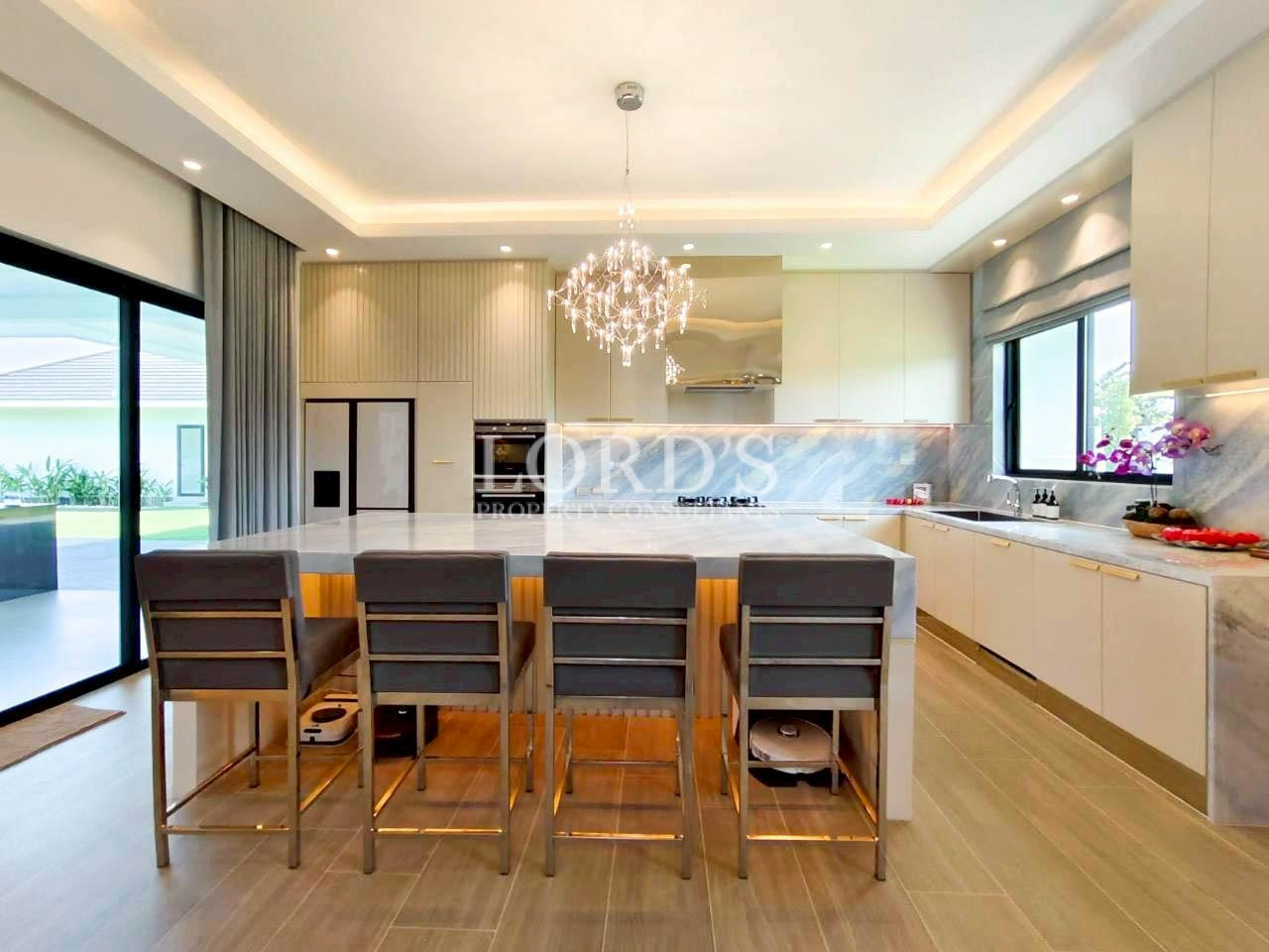 Modern dining area with chandelier and island counter