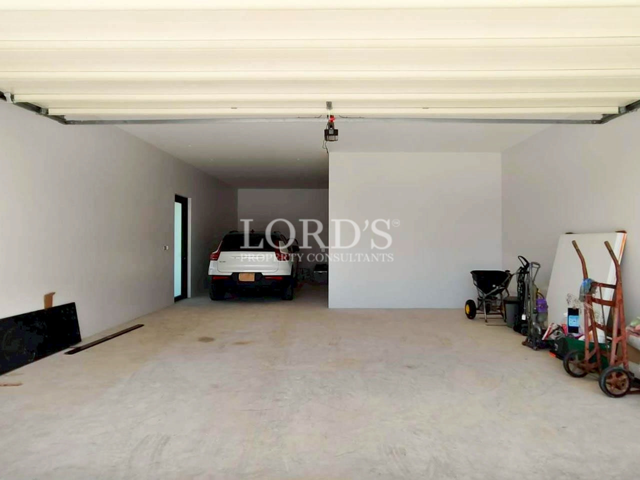 Covered parking area with luxury vehicle