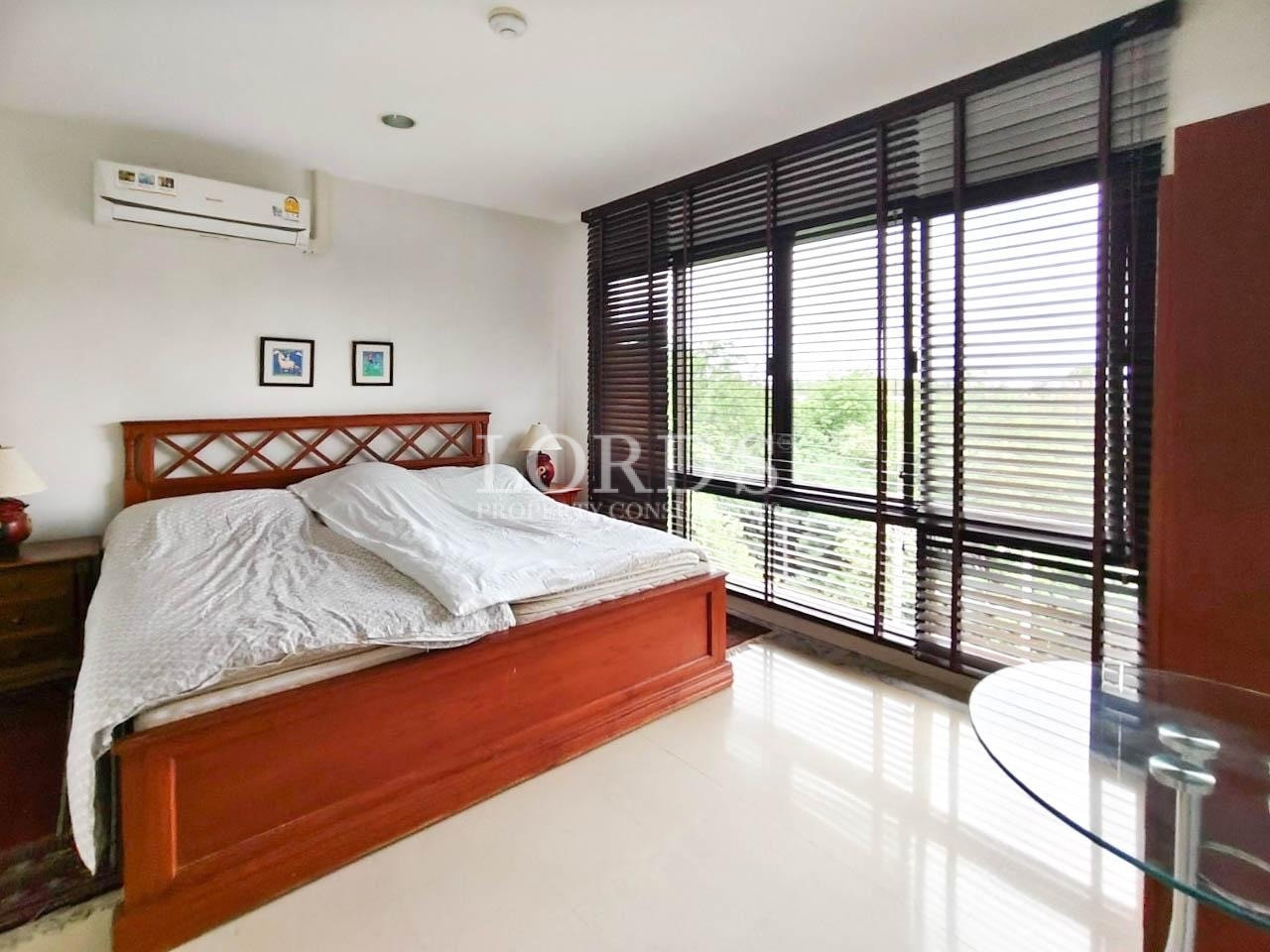 Bedroom with carved wooden bed frame