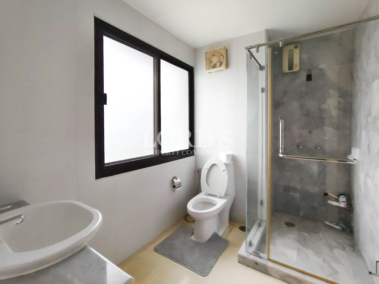 Bathroom with shower enclosure and window