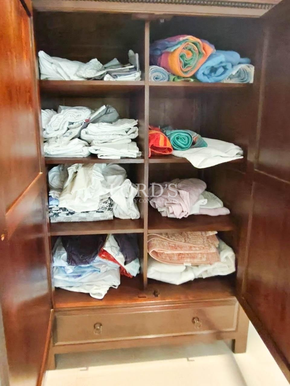 Wooden wardrobe with folded linens