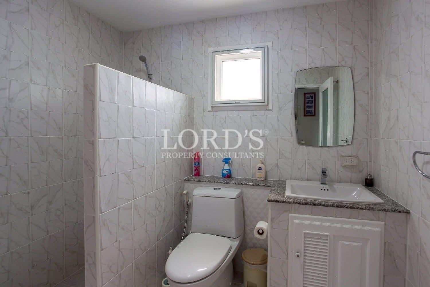 Compact bathroom with tiled walls