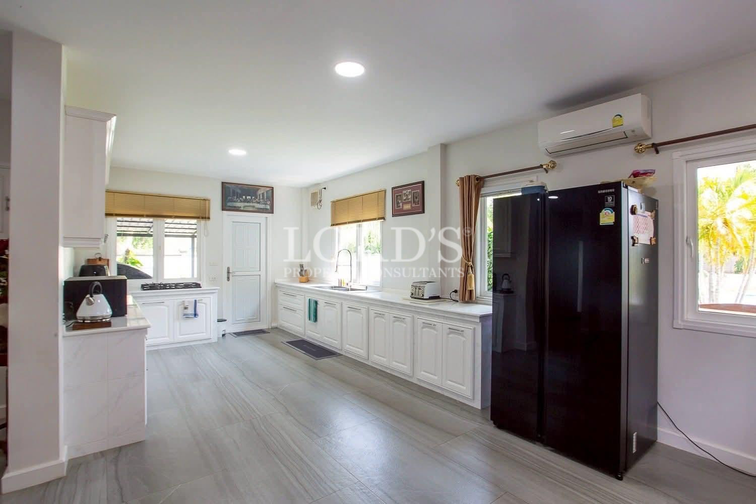 Modern kitchen with black refrigerator