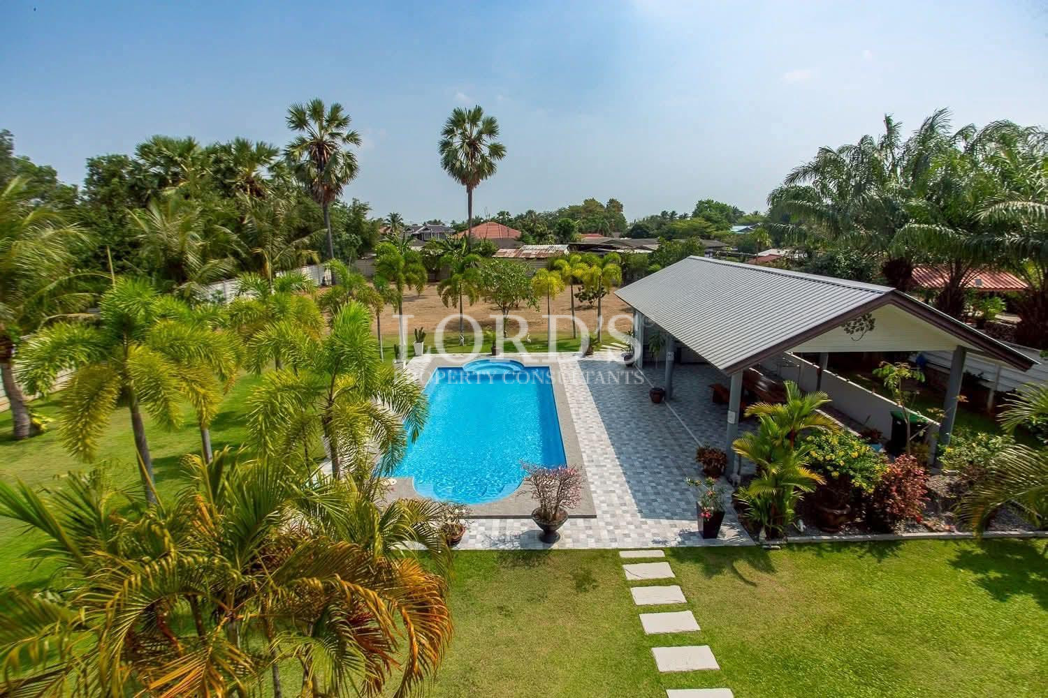Aerial pool villa surrounded by greenery