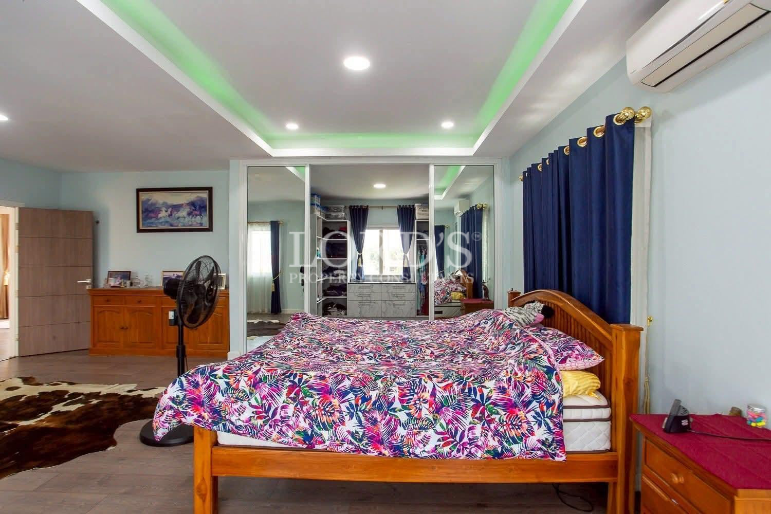 Spacious bedroom with colorful bedspread